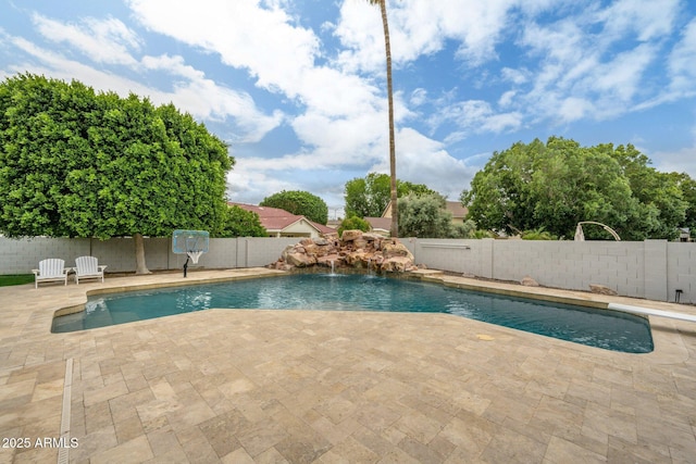 view of swimming pool featuring a fenced backyard and a patio