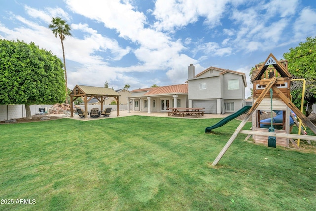 view of yard with a gazebo, a playground, and a patio area