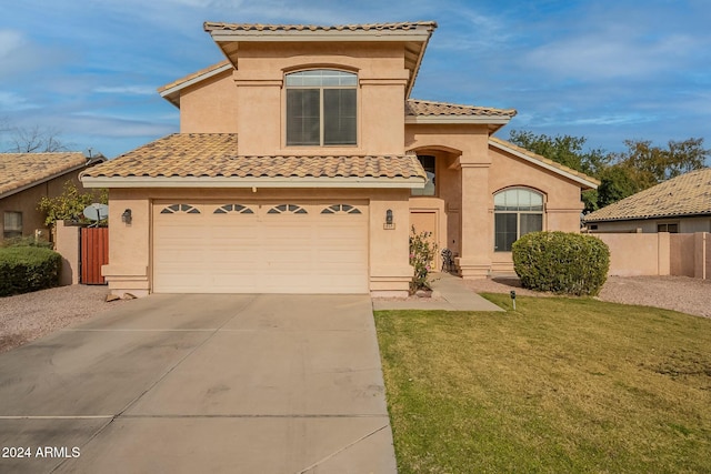 mediterranean / spanish-style home with a front lawn and a garage