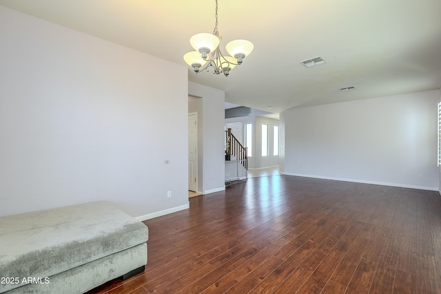 interior space featuring a notable chandelier and dark hardwood / wood-style flooring