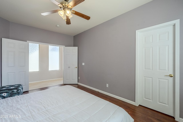 bedroom with ceiling fan and dark wood-type flooring