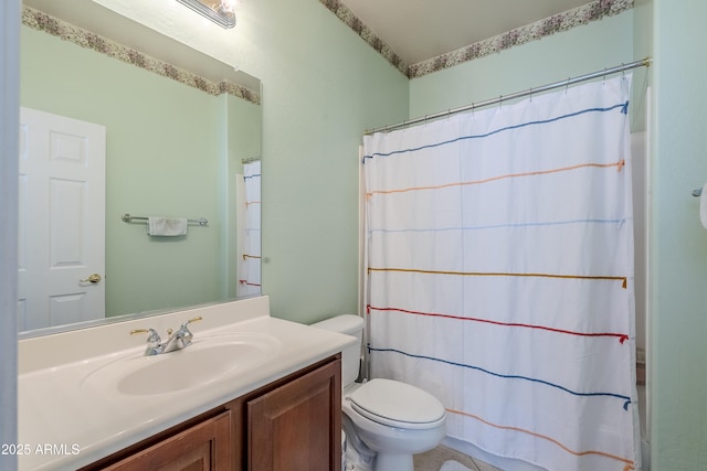 bathroom featuring toilet, a shower with shower curtain, and vanity