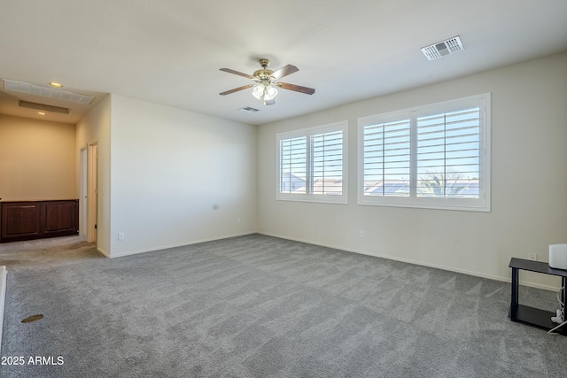 unfurnished room featuring ceiling fan and light carpet