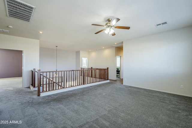 carpeted empty room with ceiling fan with notable chandelier