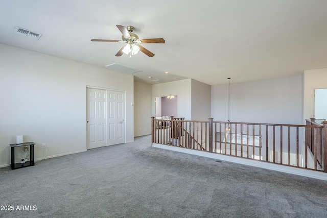 carpeted spare room with ceiling fan