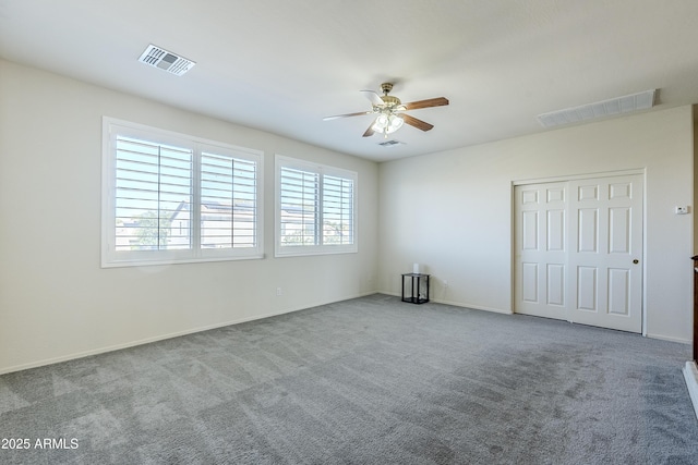 unfurnished bedroom featuring ceiling fan, light colored carpet, and a closet