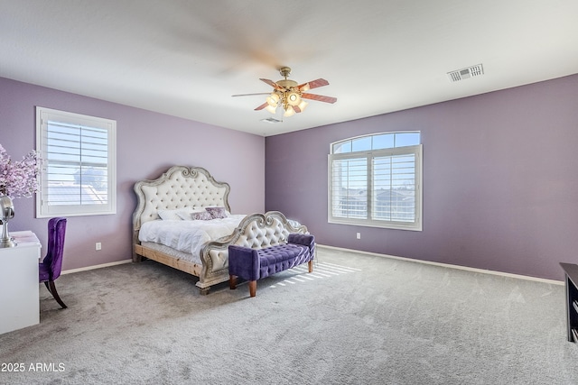 bedroom featuring ceiling fan, multiple windows, and carpet