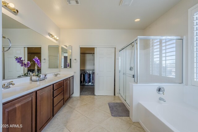 bathroom with vanity, tile patterned floors, and shower with separate bathtub