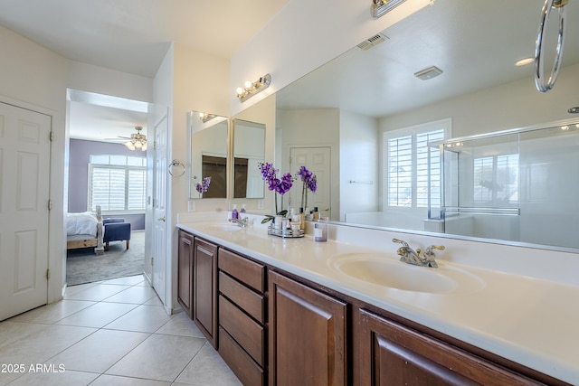 bathroom with a shower with shower door, vanity, ceiling fan, and tile patterned flooring