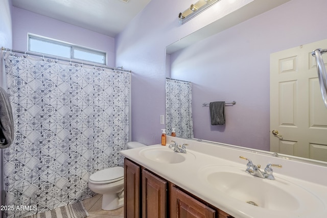 bathroom with toilet, tile patterned flooring, and vanity