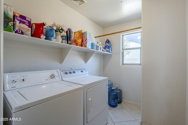 laundry area with light tile patterned flooring and independent washer and dryer