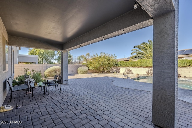 view of patio with a fenced in pool