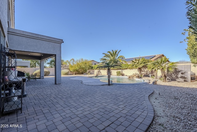 view of patio / terrace with a fenced in pool