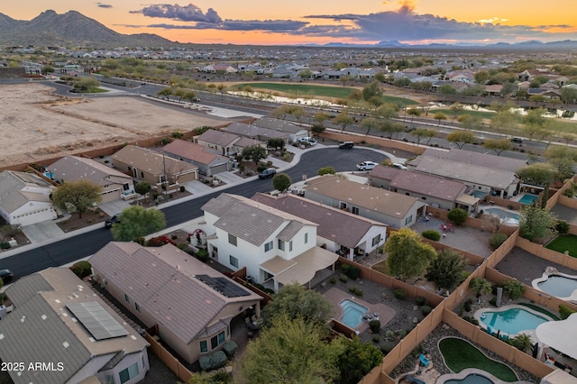 26234 W Behrend Dr, Buckeye, AZ 85396 - aerial view at dusk featuring a mountain view and a residential view