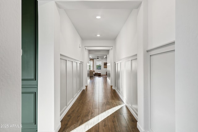 hall with dark wood-style floors and recessed lighting