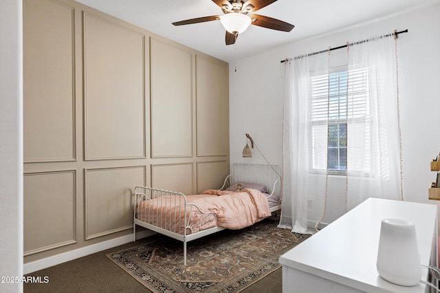 bedroom with a decorative wall and a ceiling fan