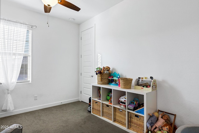 playroom with a ceiling fan, carpet flooring, and baseboards