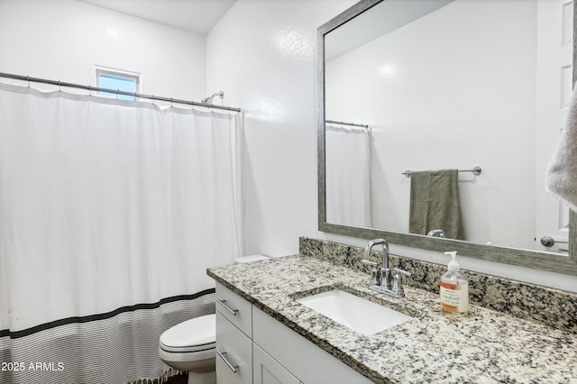 full bathroom featuring toilet and vanity