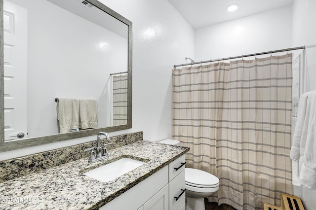 bathroom featuring toilet, vanity, recessed lighting, and a shower with curtain