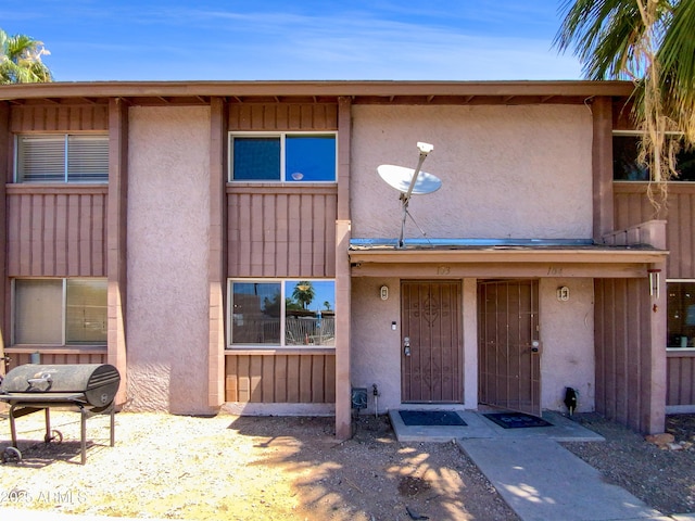 1750 E Mateo Cir Unit 103, Mesa, AZ 85204 - view of front of home featuring stucco siding and board and batten siding
