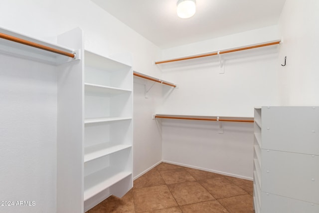 walk in closet with tile patterned flooring