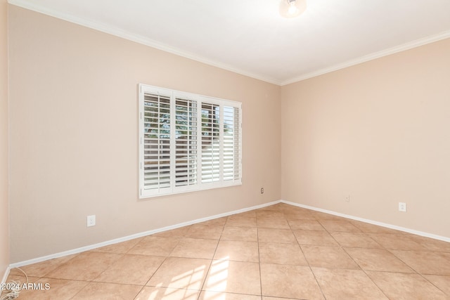 tiled spare room featuring ornamental molding