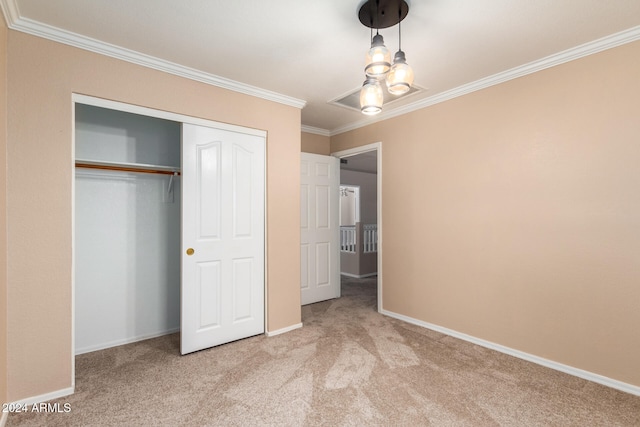 unfurnished bedroom with a closet, light carpet, and crown molding