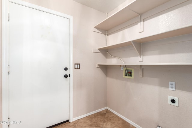 laundry area with hookup for a washing machine, light tile patterned flooring, and hookup for an electric dryer