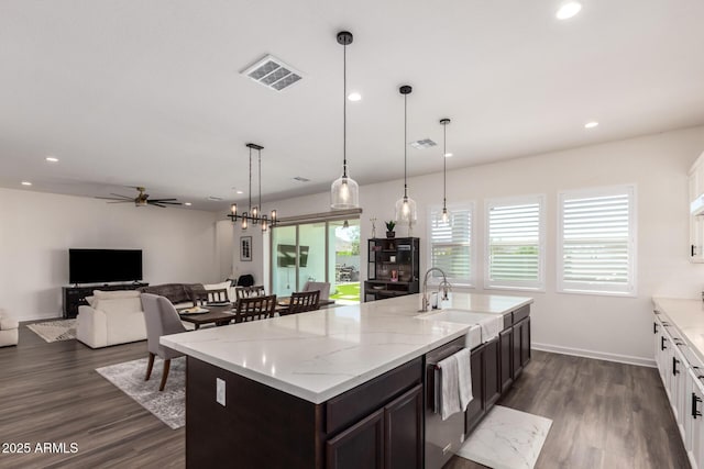 kitchen featuring a sink, stainless steel dishwasher, dark wood-style flooring, ceiling fan, and dark brown cabinets