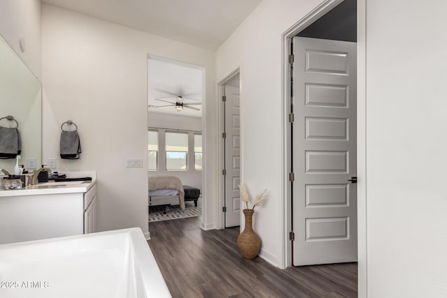 ensuite bathroom featuring wood finished floors, ceiling fan, and vanity