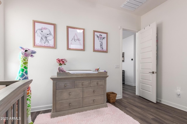 bedroom featuring dark wood finished floors and baseboards
