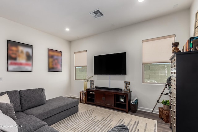 living area with wood finished floors, baseboards, and recessed lighting