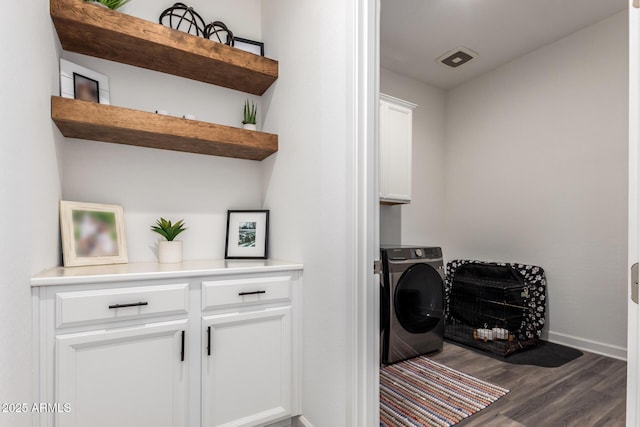 laundry room with washer / dryer, wood finished floors, baseboards, and cabinet space