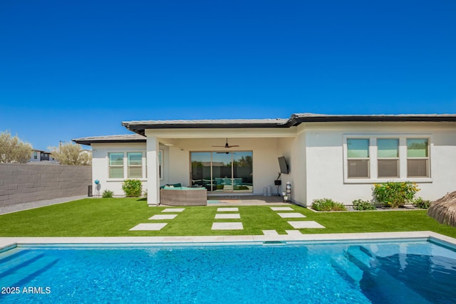 rear view of property featuring outdoor lounge area, a ceiling fan, stucco siding, and a patio area