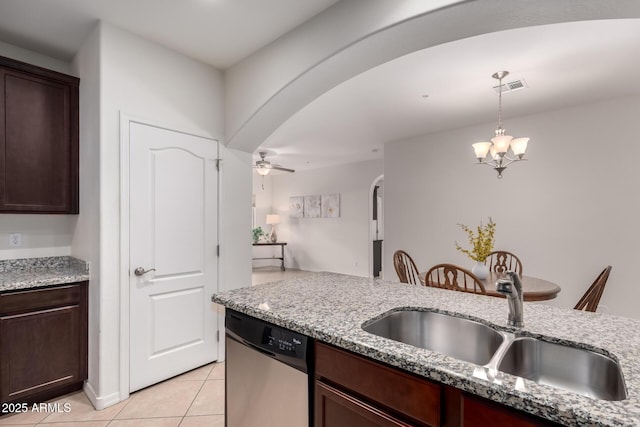 kitchen with visible vents, decorative light fixtures, dishwasher, arched walkways, and a sink