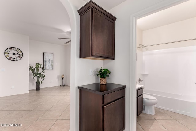 full bathroom with toilet, a ceiling fan, shower / bathing tub combination, tile patterned flooring, and vanity