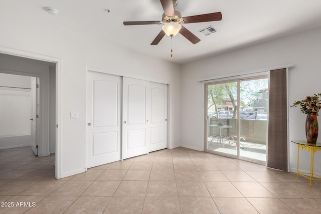 unfurnished bedroom with access to exterior, visible vents, and light tile patterned floors