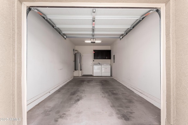 garage featuring a garage door opener, washing machine and dryer, and water heater