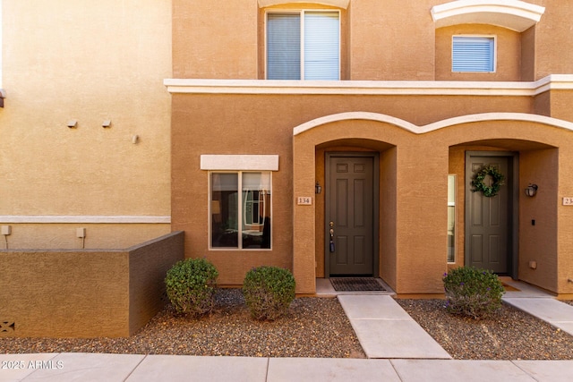 view of exterior entry with stucco siding