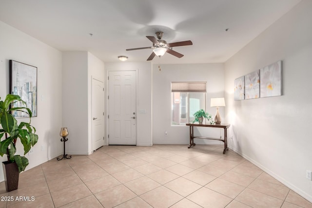 entrance foyer with light tile patterned floors, baseboards, and ceiling fan