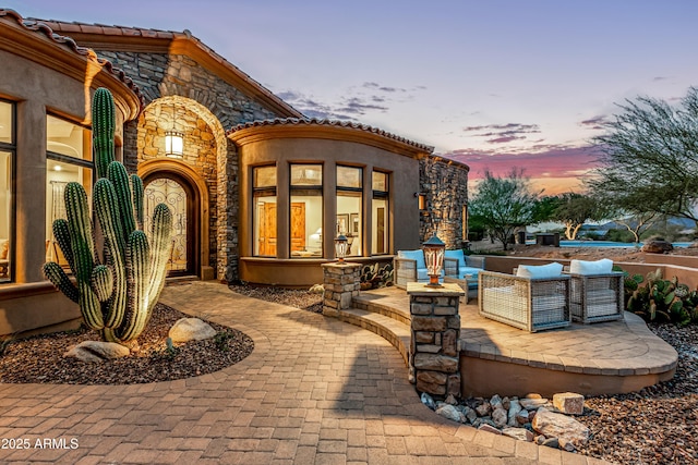 patio terrace at dusk with an outdoor living space