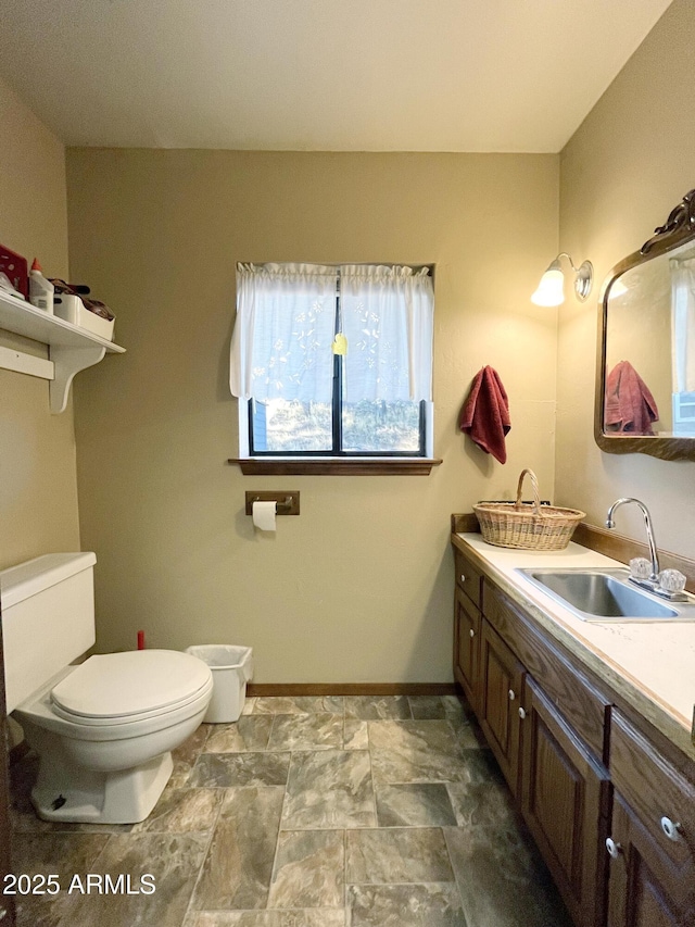5408 Corda Ln, Show Low, AZ 85901 - bathroom with toilet, baseboards, vanity, and stone finish flooring