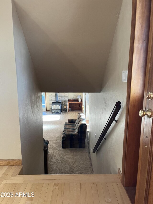 5408 Corda Ln, Show Low, AZ 85901 - stairway featuring a wood stove, a textured wall, and baseboards