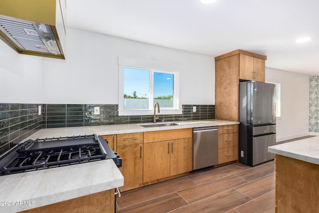 kitchen with backsplash, dark hardwood / wood-style flooring, sink, and stainless steel appliances