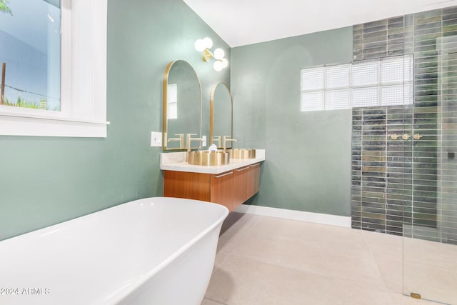 bathroom featuring plus walk in shower, vanity, and tile patterned floors