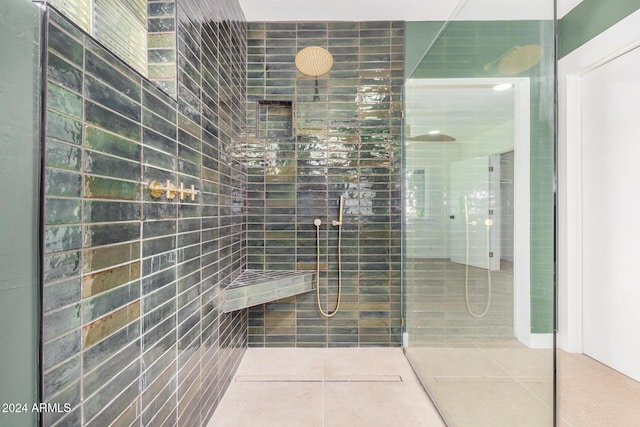 bathroom featuring tile patterned floors and tiled shower