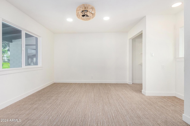 unfurnished room featuring light colored carpet