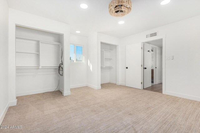 unfurnished bedroom featuring light carpet