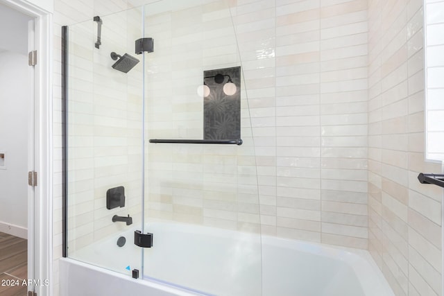 bathroom featuring bath / shower combo with glass door and hardwood / wood-style flooring