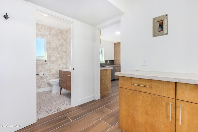 kitchen with a wealth of natural light and stainless steel dishwasher